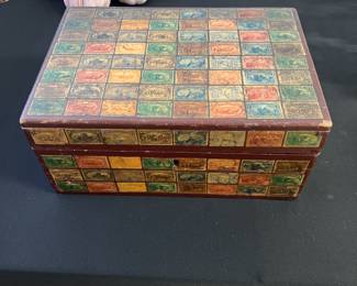 Vintage wooden box with antique English stamps on the exterior.