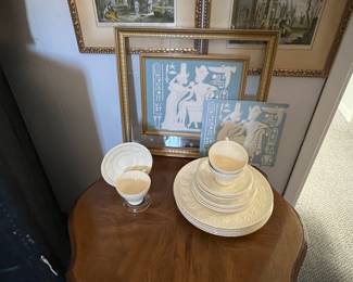Vintage Wedgewood dishes. 3 tea cups, 3 tea cup saucers, 4 dinner plates, 4 Bread & Butter plates. Behind dishes is a vintage porcelain framed picture of the "Egyptian Pharaoh and his Queen"