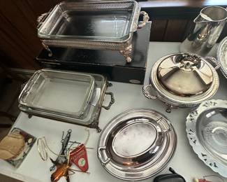 A table filled with assorted silver plate serving pieces! 