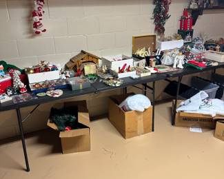 This is a wide shot of two banquet tables filled with Christmas from vintage to new!