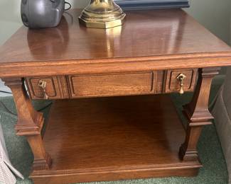 An absolutely beautiful oak end table with drawer and original pulls!