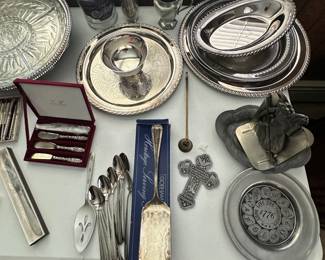 A table filled with assorted silver plate serving pieces! 