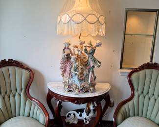 Monte lamp on marble top center table with pair of Victorian parlor chairs with tapestry fabric