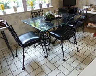 Wrought iron glass top table with 4 chairs