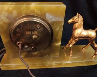 Lot #8: Vintage General Electric Sessions clock wit from the 1940's with gold-colored horse. The Streamline Moderne design clock works! Sits on a green onyx-like base. 12" long x 3" wide x 7" tall