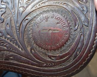 Billy Royal Western saddle with silver tone metal stirrups and hand tooled leather, 17" seat