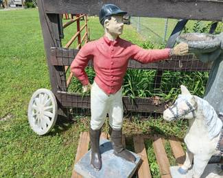 painted concrete jockey standing on a base 14" x 14" and 44" tall, his arm is wired for a light