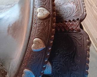 Billy Royal Western saddle with silver tone metal stirrups and hand tooled leather, 17" seat
