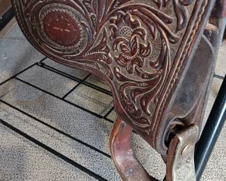 Billy Royal Western saddle with silver tone metal stirrups and hand tooled leather, 17" seat
