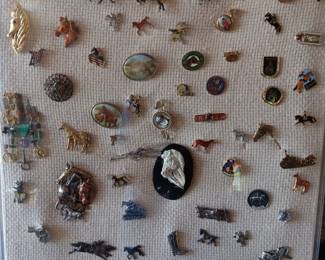 Lot #46: plexiglass display box full of assorted horse pins, collected by the deceased homeowner