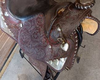 Billy Royal Western saddle with silver tone metal stirrups and hand tooled leather, 17" seat
