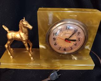 Lot #8: Vintage General Electric Sessions clock wifrom the 1940's with gold-colored horse. The Streamline Moderne design clock works! Sits on a green onyx-like base. 12" long x 3" wide x 7" tall