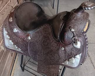 Billy Royal Western saddle with silver tone metal stirrups and hand tooled leather, 17" seat