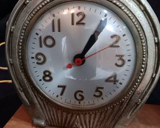 LOT #9: Brass clock with horse on wooden base.
No visible markings or signature. Base is 16" x 4 1/2". Horse is 11" tall. Weighs 8 pounds. The clock works.
