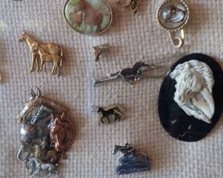 Lot #46: plexiglass display box full of assorted horse pins, collected by the deceased homeowner