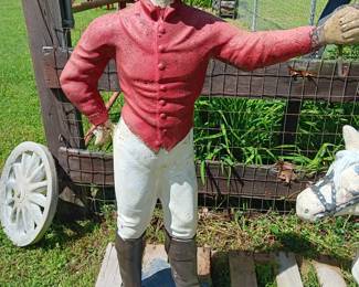 painted concrete jockey standing on a base 14" x 14" and 44" tall, his arm is wired for a light