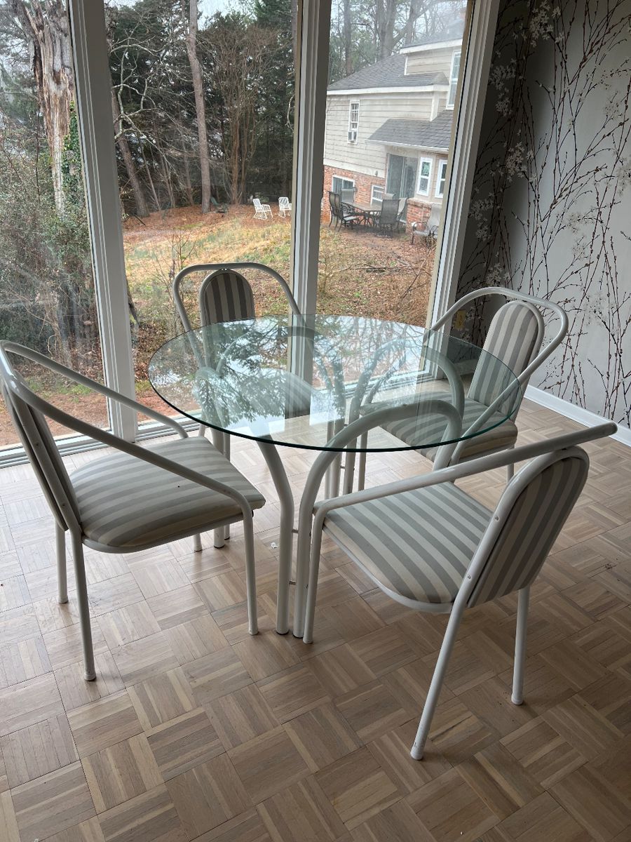 Munich round glass table set with 4 chairs. Table 42 inch round. Chairs, 34 high, 18 wide, seat height 18 inches.