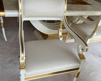 Custom modern design gold and opaque white dining room table with glass center. Comes with 6 chairs and 2 leaves to extend to 112 inches long! Chairs are very comfortable with rolled backs and gold accents. Stunning statement furniture. Table is 76 inches by 44 without leaves, each leaf is 18 inches wide.
Chairs are 3 ft high, 22 inches wide and seat height 19 inches.