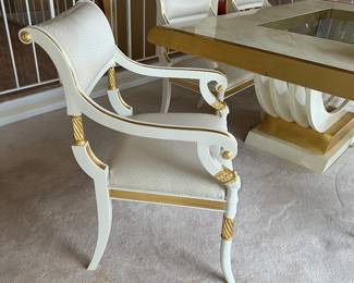 Custom modern design gold and opaque white dining room table with glass center. Comes with 6 chairs and 2 leaves to extend to 112 inches long! Chairs are very comfortable with rolled backs and gold accents. Stunning statement furniture. Table is 76 inches by 44 without leaves, each leaf is 18 inches wide.
Chairs are 3 ft high, 22 inches wide and seat height 19 inches.