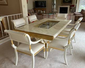 Custom modern design gold and opaque white dining room table with glass center. Comes with 6 chairs and 2 leaves to extend to 112 inches long! Chairs are very comfortable with rolled backs and gold accents. Stunning statement furniture. Table is 76 inches by 44 without leaves, each leaf is 18 inches wide.
Chairs are 3 ft high, 22 inches wide and seat height 19 inches.