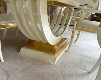 Custom modern design gold and opaque white dining room table with glass center. Comes with 6 chairs and 2 leaves to extend to 112 inches long! Chairs are very comfortable with rolled backs and gold accents. Stunning statement furniture. Table is 76 inches by 44 without leaves, each leaf is 18 inches wide.
Chairs are 3 ft high, 22 inches wide and seat height 19 inches.