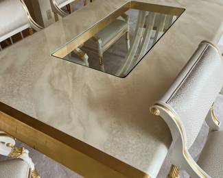 Custom modern design gold and opaque white dining room table with glass center. Comes with 6 chairs and 2 leaves to extend to 112 inches long! Chairs are very comfortable with rolled backs and gold accents. Stunning statement furniture. Table is 76 inches by 44 without leaves, each leaf is 18 inches wide.
Chairs are 3 ft high, 22 inches wide and seat height 19 inches.