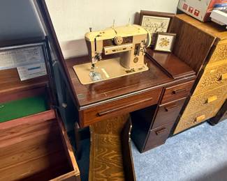A nice vintage singer, sewing machine in this beautiful cabinet! Below that is a beautiful handmade wooden baby doll crib