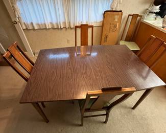 This house has beautiful mid-century modern furniture also! This is the dining room table complete with belt pads for the top four chairs for around and one extra chair for company!