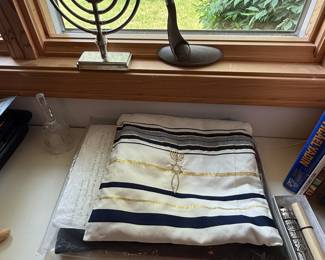 This is a small collection of items used for the Jewish Faith. A prayer shawl, menorah, and more. (Books too!)