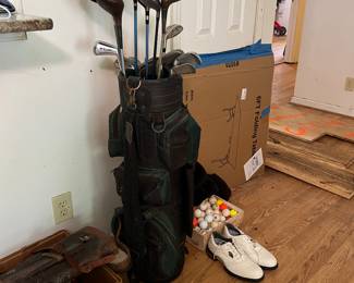 Sportsman's Corner - Assorted golf clubs (mix of irons and woods in vintage style golf bag. Golf Shoes and mixed golf balls.