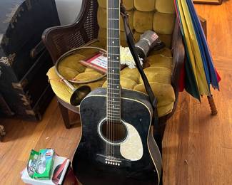 Delta Acoustic Guitar - classic 6 string featuring a high-gloss body with white binding and pickguard. Includes strap. Ideal for beginners, campfire players, or wall decor in a music themed room.