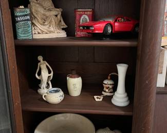 Mixed Collectibles &Decor Shelf - Ceramics, Model Car, Shells & More. Tasco Tin Can, Miniature Statue of Michelangelo's Pieta, Red Diecast Ferrari Model Car Display, Prince Albert Tobacco Tin.