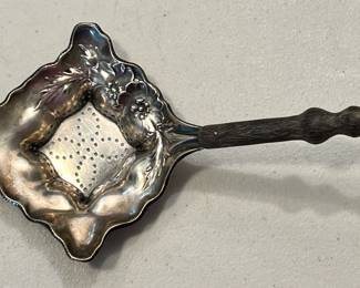 Sterling tea strainer with wooden handle
