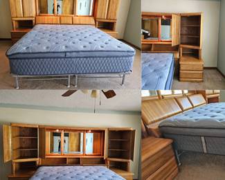 Headboard made of oak and features a bed with built-in storage, mirrored panels, and overhead lighting
