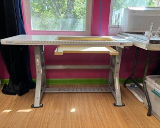 Sew perfect sewing machine table. The table measure 20 1/4 inches by 47 inches. The opening for the machine measures 12 1/2 by 24