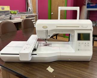 A BabyLock Flourish embroidery machine with hoops and stabilizer. Owners manual included.