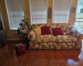 Sofa in Sunroom, with great repurposed sewing machine base table next to sofa, decor
