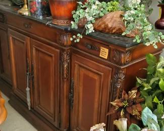 artificial plants and marble topped credenza