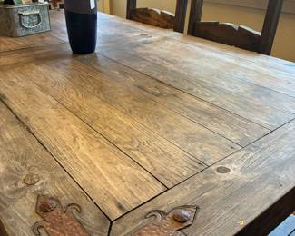 rustic western table with metal corner detail and six chairs
