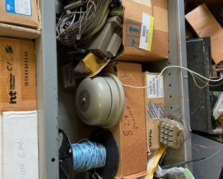 Lots of phone equipment; tools; boxes; shelves