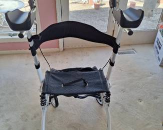 White new foldable walker with brakes and seat and armrest