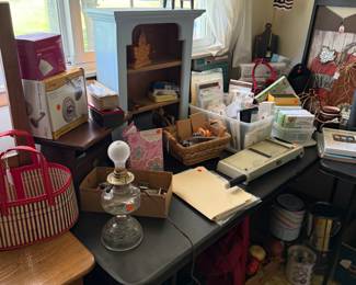 A banquet table filled with small collectible and more craft items