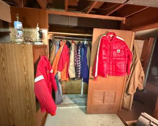 This closet is filled with men’s Carhart outdoor jacket and assorted items