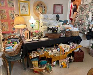LINENS ON THE OTHER SIDE OF THE ROOM. VINTAGE AND MODERN. SEWING BASKET STUFFED FULL.