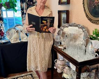 LIBBY IN VINTAGE CLOTHING GETTING READY TO PREPARE A GREAT MEAL FOR THE GUESTS WITH THE HELP OF THE KIMBALL COOKBOOK!