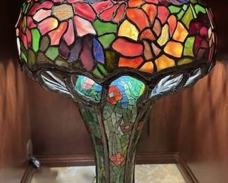 Tiffany style stained glass and bronze base lamp.