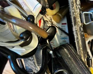 Vintage doctor's bag with stethoscope and otoscope and other instruments