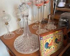 Small occasional table with unique glassware on top.