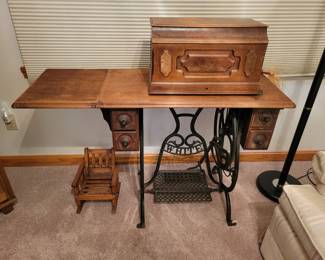 Whute antique sewing machine treadle.