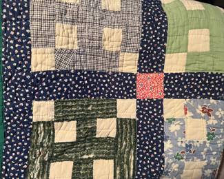 There is a nice collection of hand stitched quilts including this one